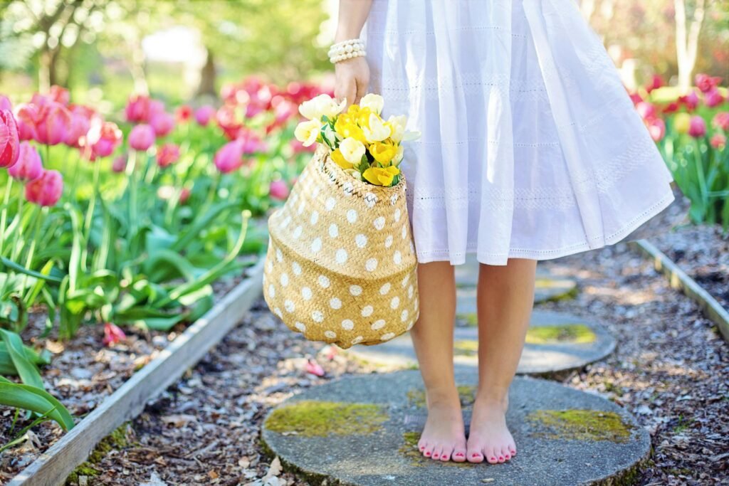 women standing in garden holding basket for gardening