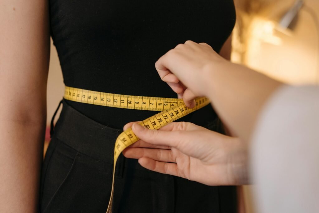 Woman measuring waist to slim down