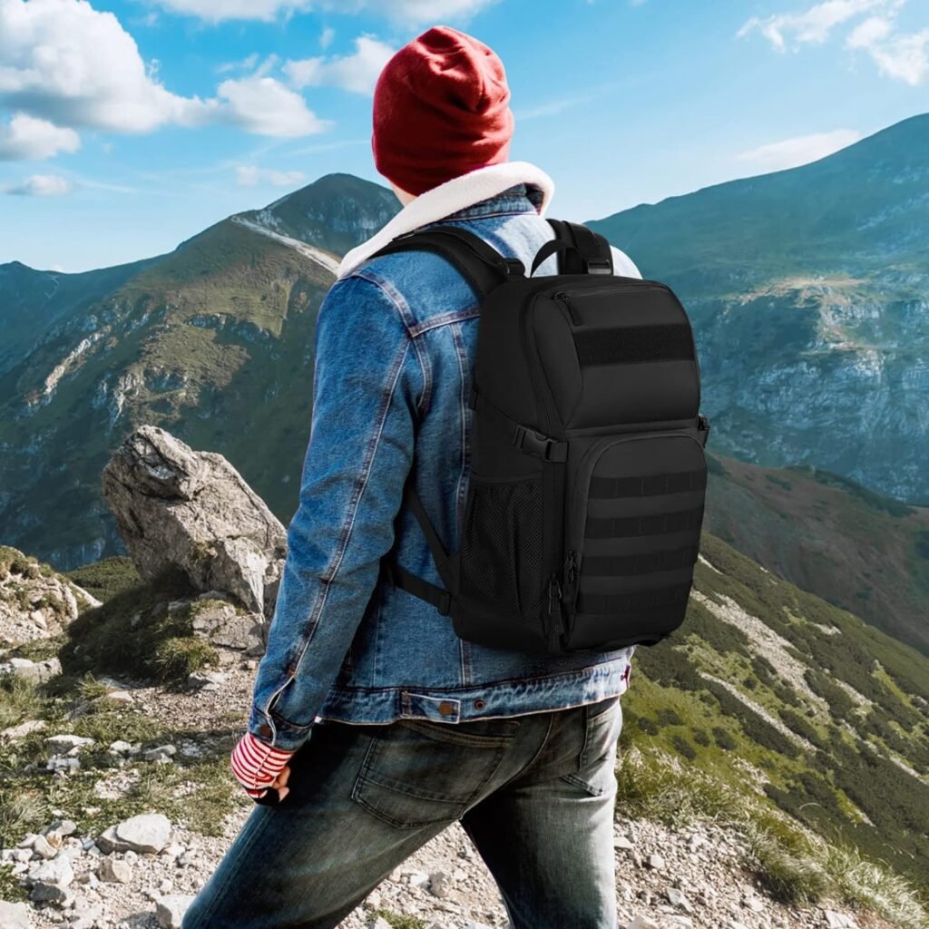 Back of a man wearing a rucksack backpack while looking out over a mountain range