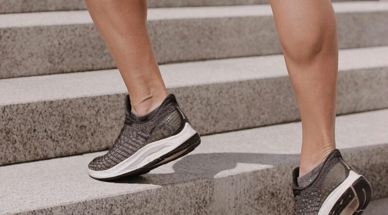 Dynamic shot of athletic legs in sneakers climbing stairs, perfect for fitness and lifestyle themes.